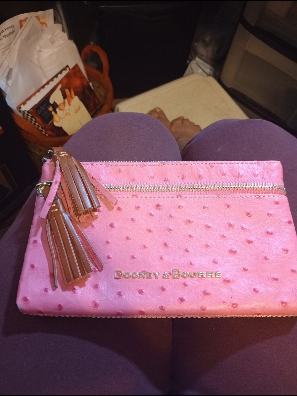 Dooney & Bourke Pink Ostrich-Embossed Tassel Zip Clutch.